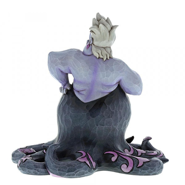 "Ursula with Scene Disney Traditions sculptuur: Laat je betoveren door dit meeslepende beeld, ontworpen door Jim Shore, dat Ursula's onderwaterrijk en duistere charme tot leven brengt, ideaal voor Disney-fans en kunstliefhebbers."